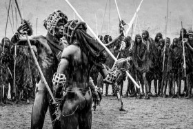 The Face Off - two Suri men in the rain face each other before a Donga fight begins.