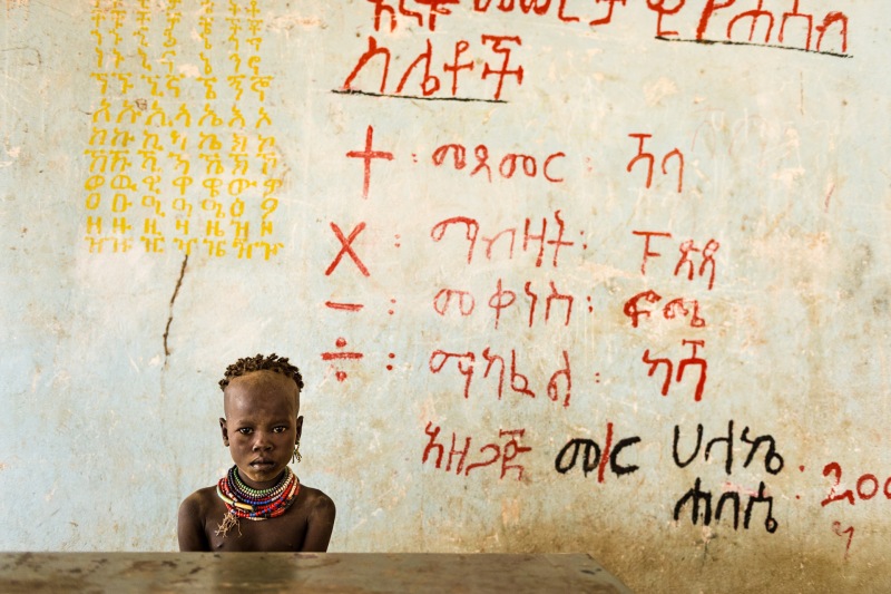 A young Kara girl in a school house, Dus Village.