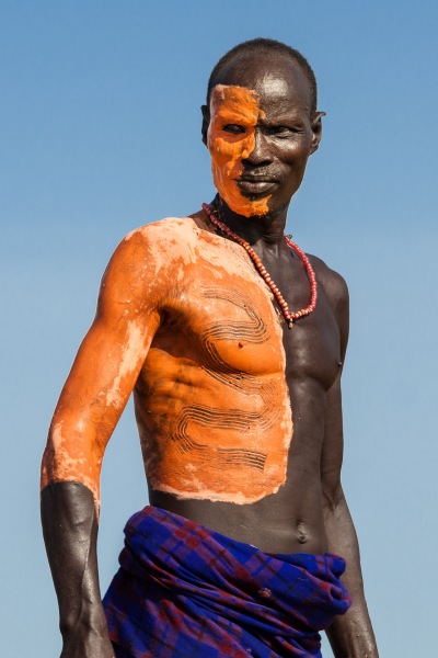 A Kara tribe elder has just decorated his body with fresh clay "paint" in perperation for the Bull Jump ceremony in Dus Village.